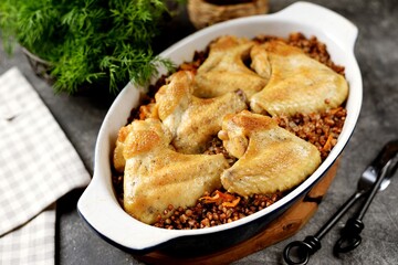 Chicken wings baked with buckwheat in the oven