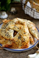 Puff pastry pies with sesame seeds.