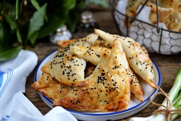 Puff pastry pies with sesame seeds.
