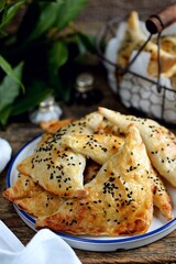 Puff pastry pies with sesame seeds.