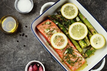 Baked salmon fillet with asparagus, lemon and olive oil. Healthy eating.