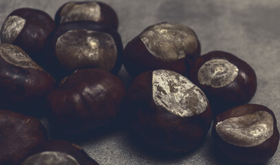 Chestnuts on gray table for natural banner concept