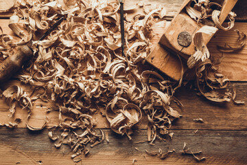 Plane jointer carpenter or joiner tool and wood shavings. Woodworking tools at wooden table