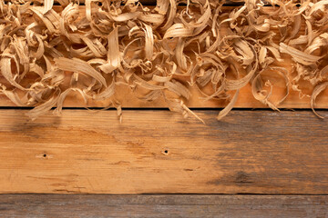 Wood shaving on table background. Wooden shaving at old plank board texture