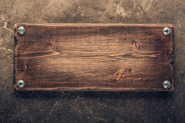 Wooden nameplate or sign board at wall background. Front view of name plate