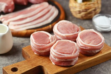 Pork medallions wrapped in bacon. Fresh raw pork tenderloin. 