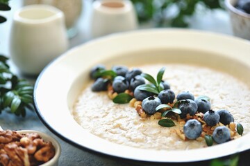 Oatmeal with walnuts and blueberries. Healthy breakfast.