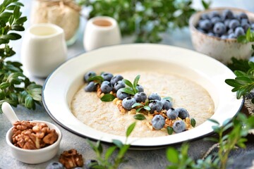 Oatmeal with walnuts and blueberries. Healthy breakfast.