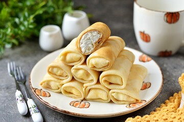 Homemade thin pancakes with cottage cheese.