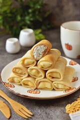Homemade thin pancakes with cottage cheese.