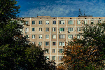Windows and balconies of the residential building. Old urban obsolete facade of panel house. The...