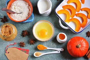 Pumpkin pie ingredients - flour, egg, peanut butter, pumpkin, milk, cinnamon, star anise and more.