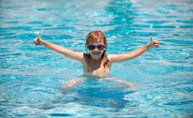 Children play in tropical resort. Family beach vacation. Child in summer swimming pool. Kids learn to swim.