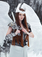 Beautiful red haired girl in steel armor with sword and white wings  dressed in white dress....