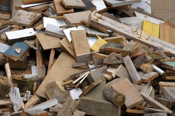 Dismantled furniture cut into pieces. There are pieces of wood. They are of irregular size. It looks like vacating of a dwelling. Detail view serving as a background with textured effect.