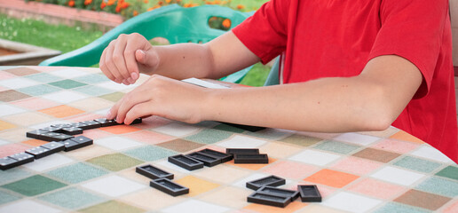 boy playing dominoes in the village