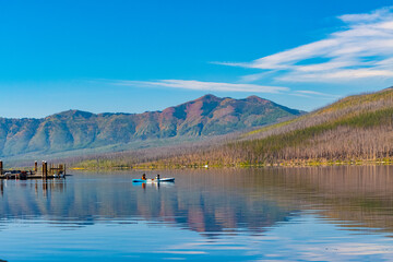 Female Kayakers on The Still Waters of Lake McDonald, Glacier National Park, Montana, USA