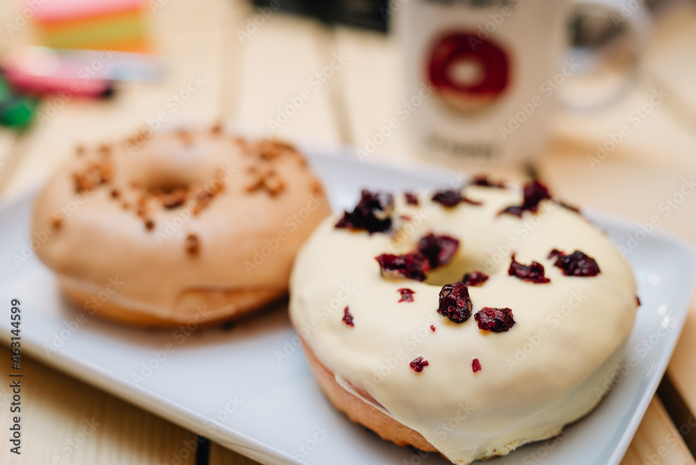 Wall mural Closeup shot of tasty donuts on a white rectangular plate