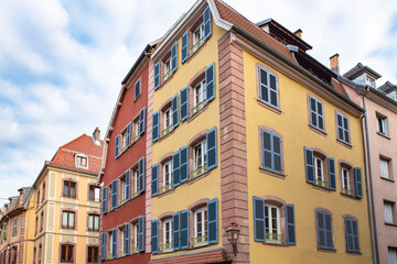 Two colourful yellow and orange houses in the city of Belfort in France