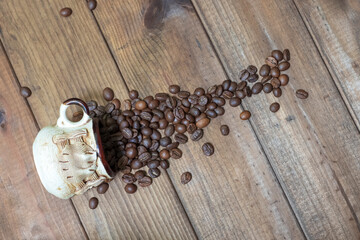 Inverted cup with coffee beans on wooden background