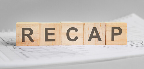 Recap word from wooden blocks on financial documents, conclusion concept