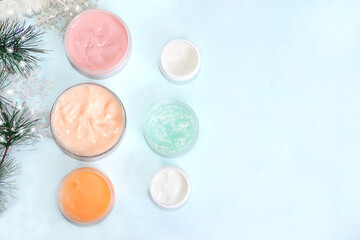 Spa and wellness composition, a set of creams for winter skin care on a light background with a place for text, a banner for advertising a store, salon, cosmetics. Modern woman concept,