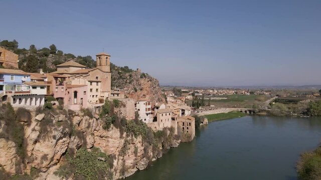 Drone shot of Miravet, Spain. Small town with medieval castel next to river.