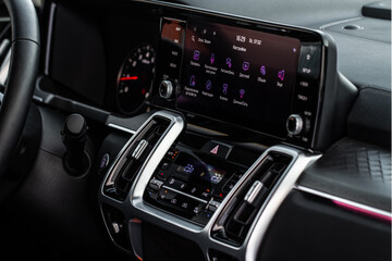 Fototapeta na wymiar Modern car media display in the interior of the car. Touchscreen monitor on the dashboard of the modern car.