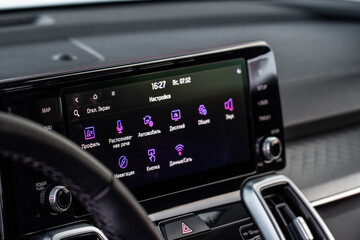 Modern car media display in the interior of the car. Touchscreen monitor on the dashboard of the...