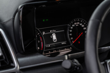 Fototapeta na wymiar Close up view of a speedometer in a car. Kilometer counter. Car speedometer and dashboard.