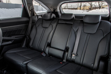 Modern SUV car inside. Leather black back passenger seats in modern luxury car. Comfortable leather seats.