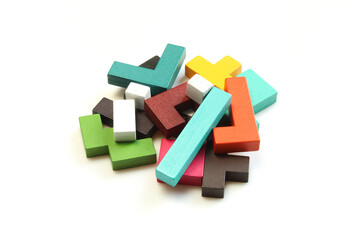 Pille of colorful wooden Katamino game parts isolated on white background