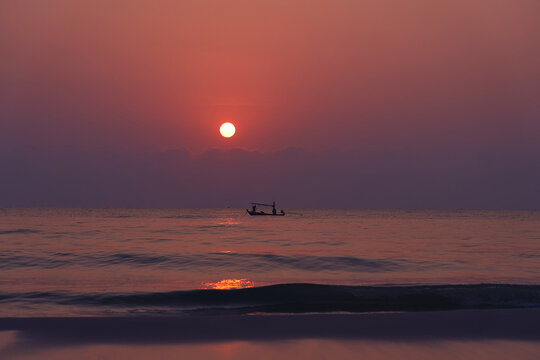 Scenic seascape of boat ob pacific colorful water on sunset