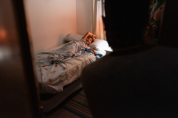 Boy wishing goodnight to father