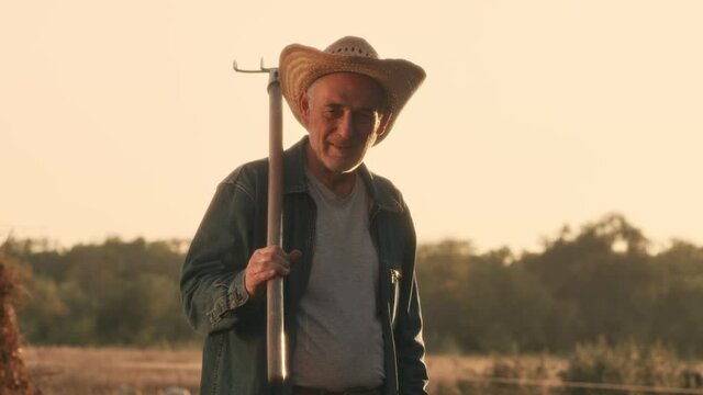 Farmer with pitchfork in field