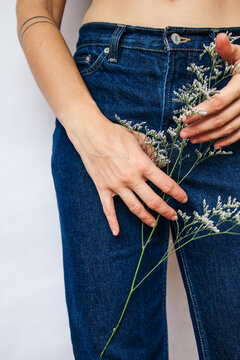 Woman's hands with tattoo holding a flower