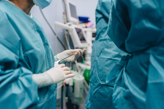 Surgeon with forceps during operation