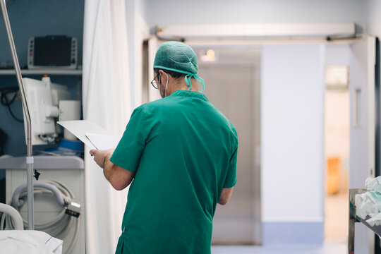 Surgeon with papers in hospital