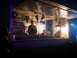Seller With Painted Face At Circus Kiosk