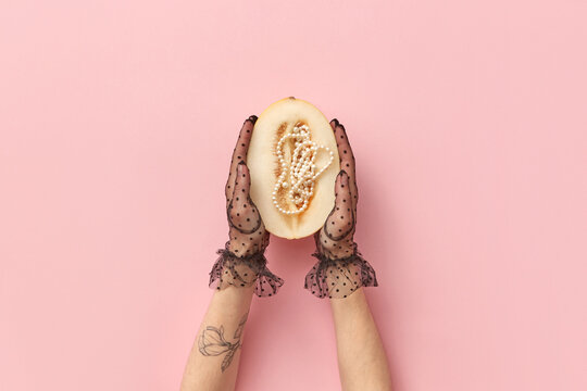 Woman in gloves holding melon with beads