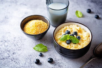 Corn porridge with fresh blueberries in a bowl