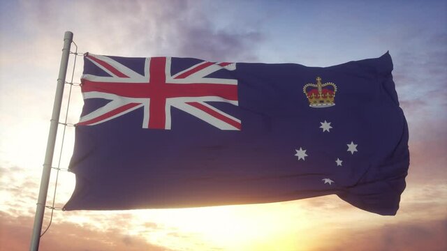 Victoria state flag, Australia, waving in the wind, sky and sun background