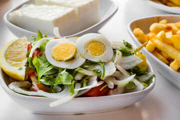 Turkish white bean salad called Piyaz on white table,above view