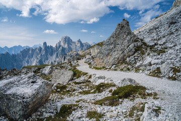 Hiking trail to Cime di Lavaredo with Cadini di Misurina mountain group in background. Dolomites, Italy
