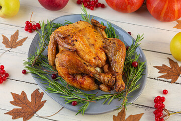 Baked whole chicken or turkey. Roasted homemade chicken with herbs. Thanksgiving day decoration