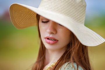 bright portrait in a hat sensual lips warm sunny background