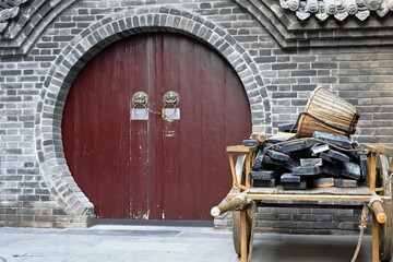 Maroon painted-round door-wooden cart-building materials. City Wall's Yongning South Gate-Xi'an-China-1588