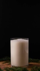 Turkish or Azerbaijan traditional Drink Ayran or Kefir dill in a glass on a wooden table on a black background. Fermented milk drink for diet. Copy space. the concept of healthy nutrition.