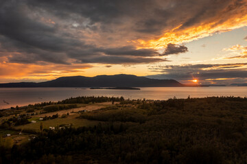 Dramatic Aerial Sunset View of Orcas Island Washington. With Lummi Island in the foreground the sun sets on this gorgeous autumn evening in the Salish Sea area of Washington state.
