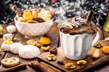 Vegan hot chocolate made with cashew nut vegetable milk with cinnamon, hazelnut and walnuts, Christmas drink with smoky steam